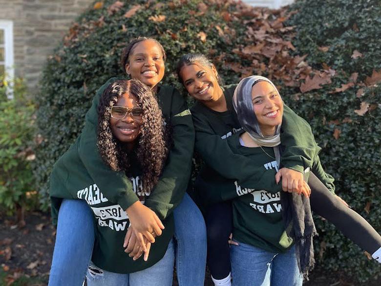 four students smiling 